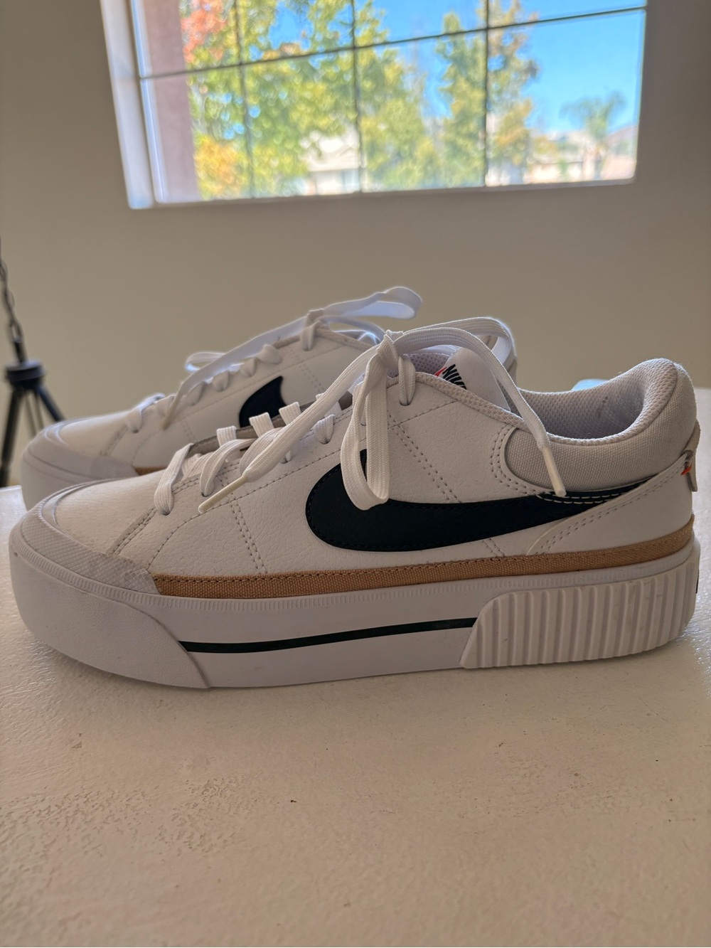 Nike Women’s White Sneakers with Black Swoosh and Tan Stripe